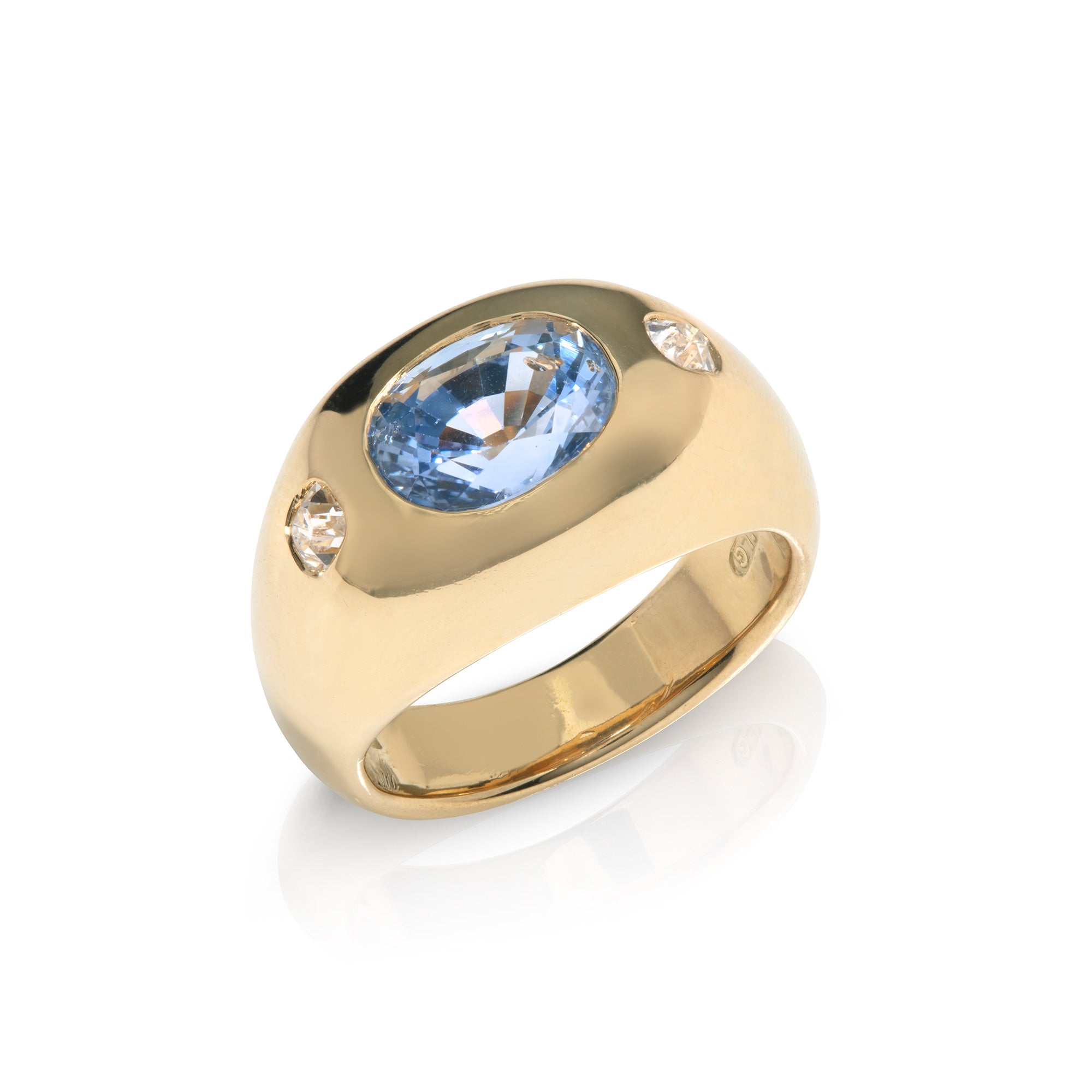 Sapphire and Diamond three stone gypsy-set ring in yellow gold on a white background