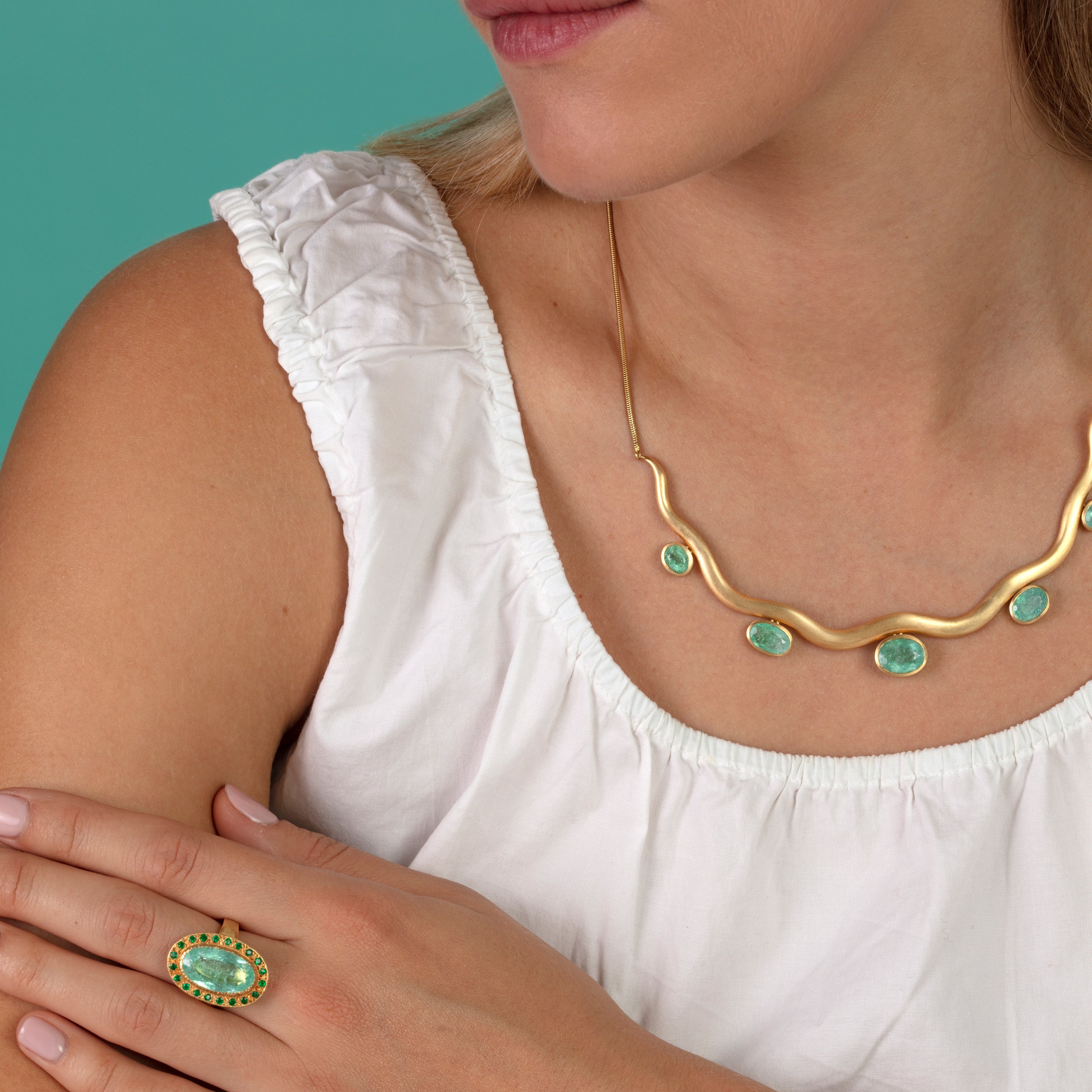 Model pictured wearing Paraiba tourmaline wave necklace and Paraiba tourmaline ring