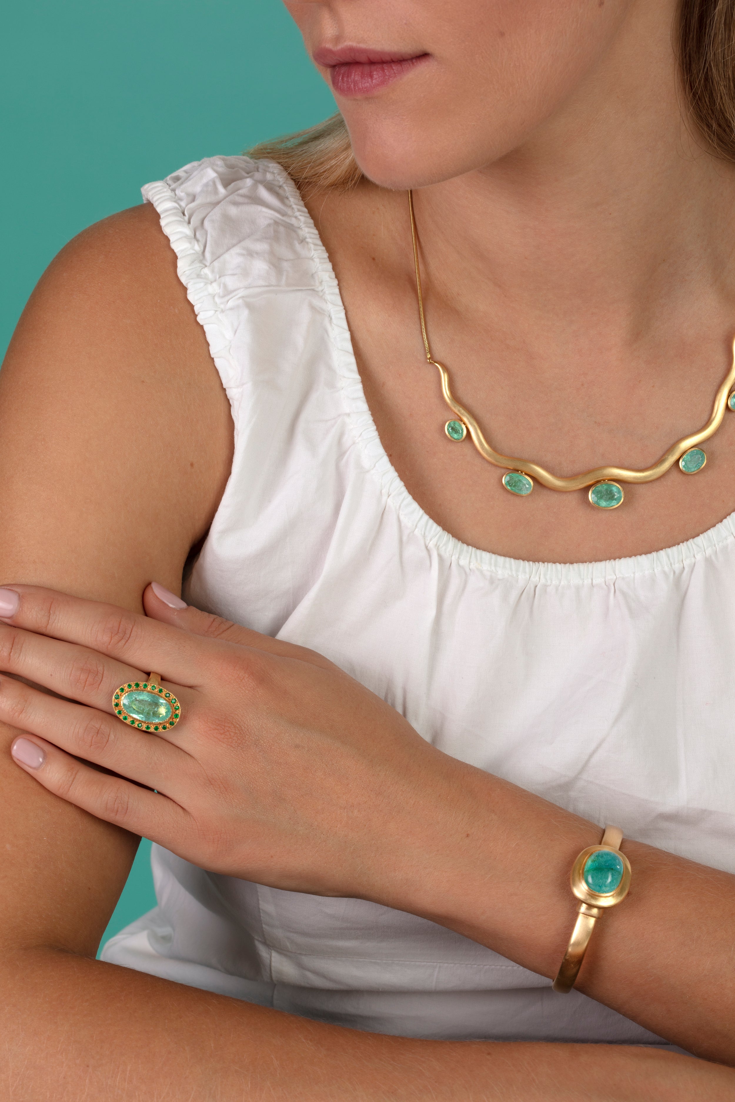 Model pictured wearing an array of Paraiba tourmaline pieces