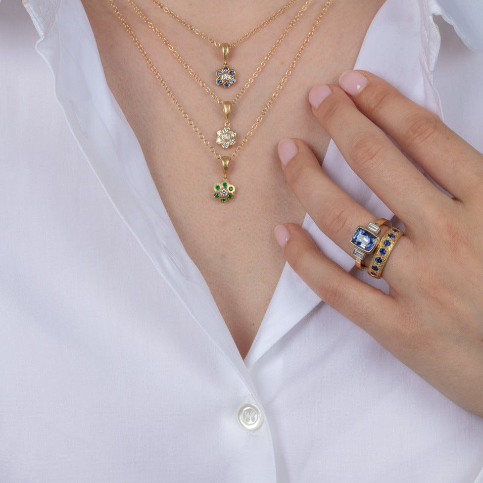 diamond and gold necklaces and sapphire rings on a model