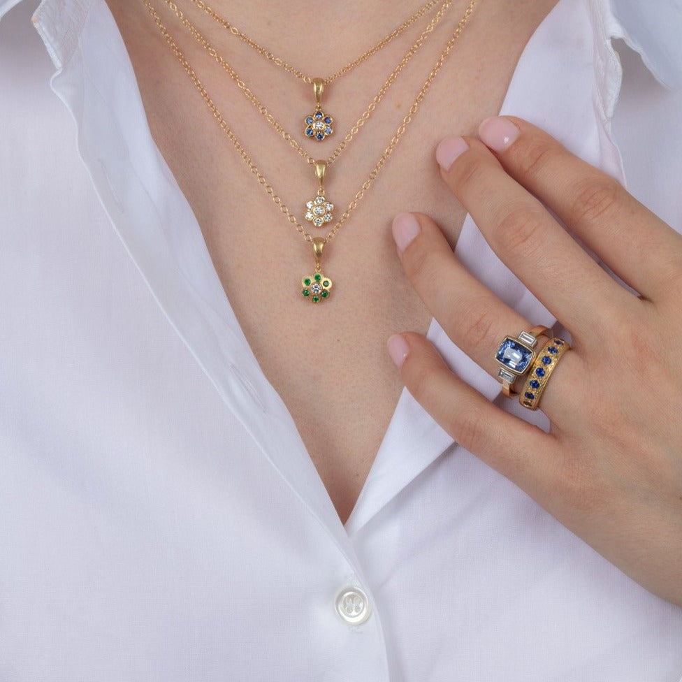 diamond and gold necklaces and sapphire and diamond gold rings on a model