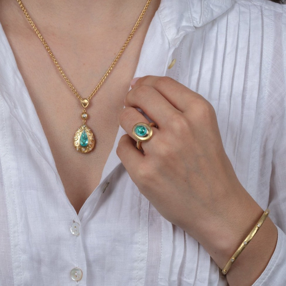 Diamond and paraiba tourmaline gold jewellery on a model