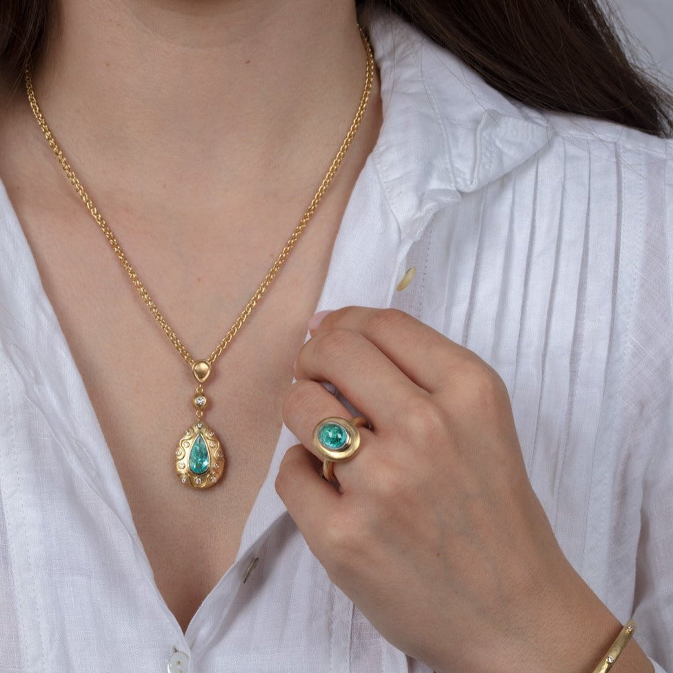 Diamond and paraiba tourmaline gold jewellery on a model