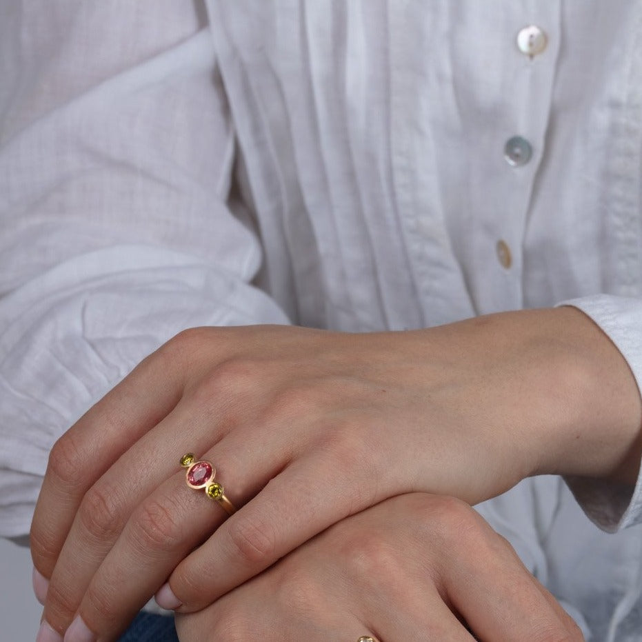 padparadscha and yellow diamond gold ring shown on a model