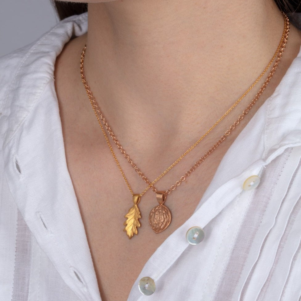 gold leaf pendant shown on a model
