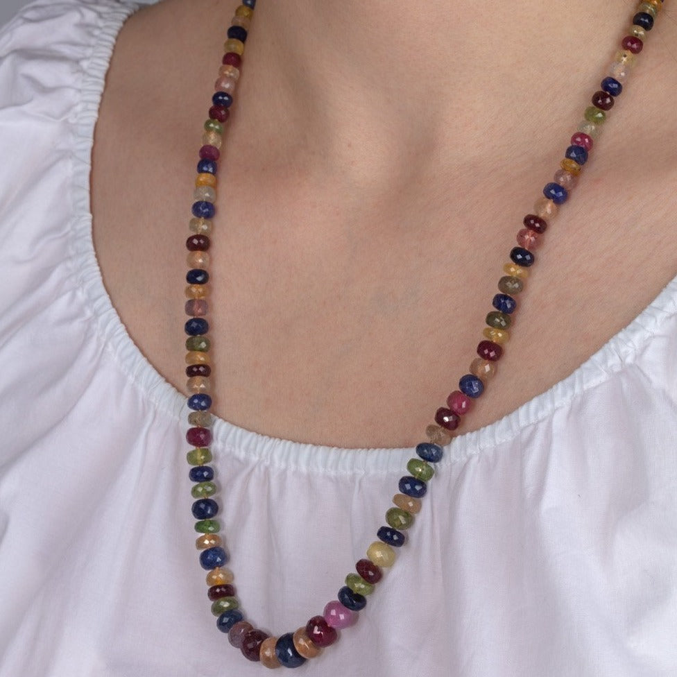multi-coloured sapphire bead necklace shown on a model
