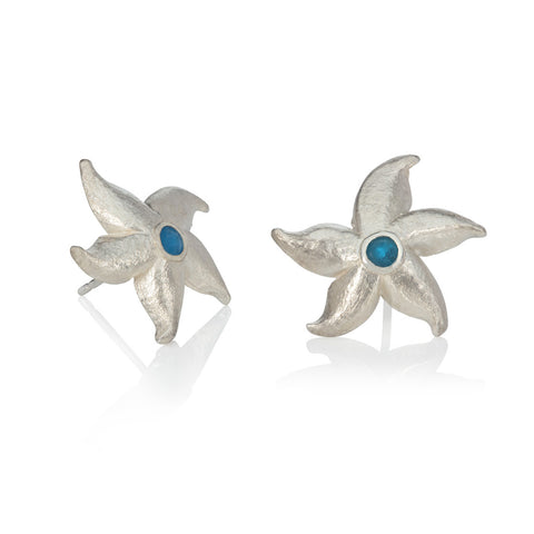 Silver starfish earrings set with apatite pictured on white background