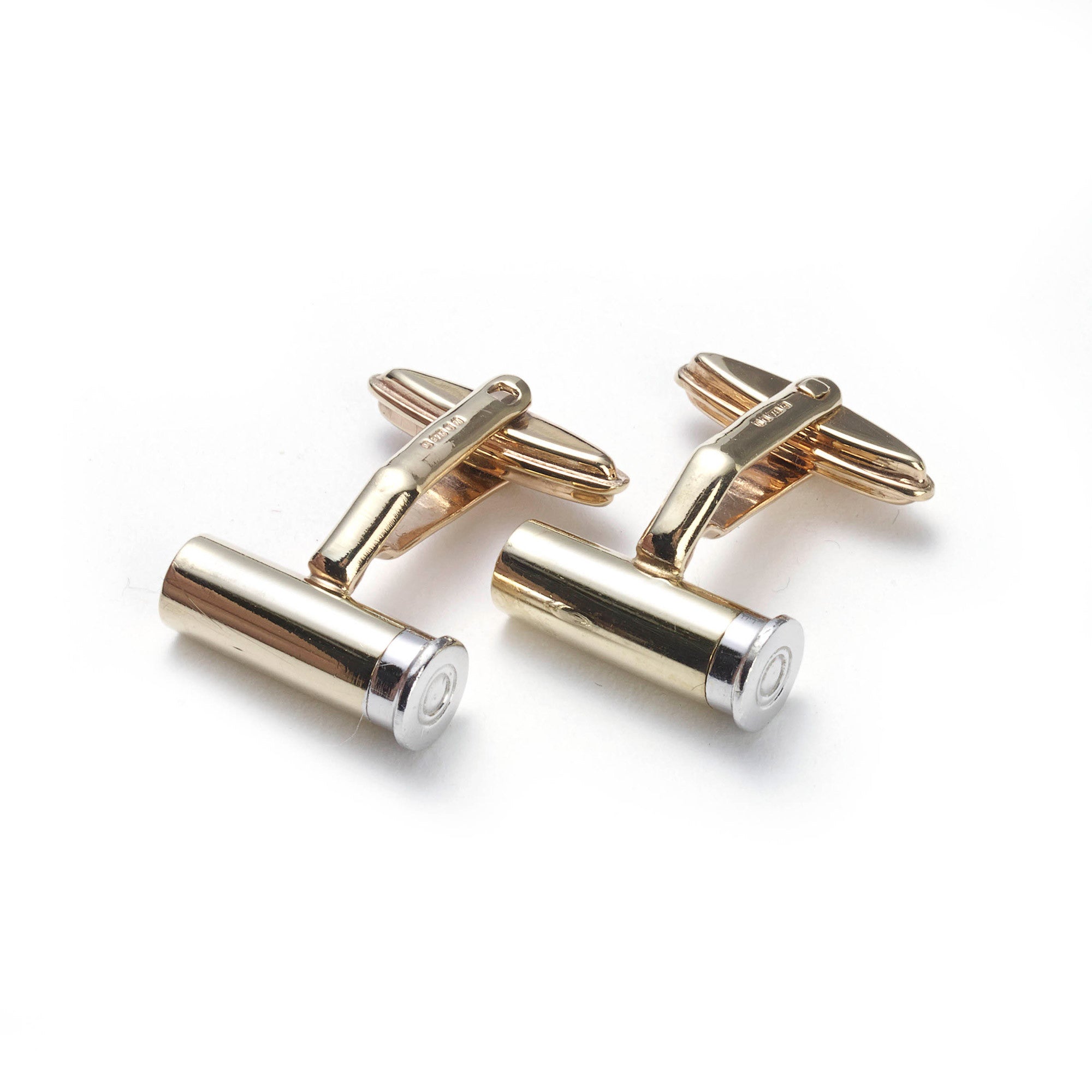 Silver and red gold shotgun cartridge cufflinks on white background