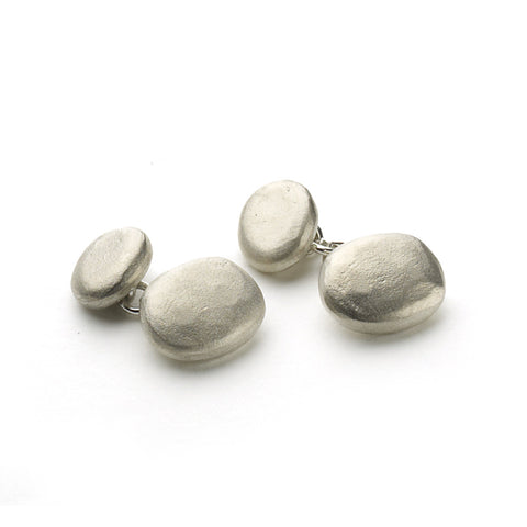 Silver pebble shaped cufflinks with chain link fixing on white background