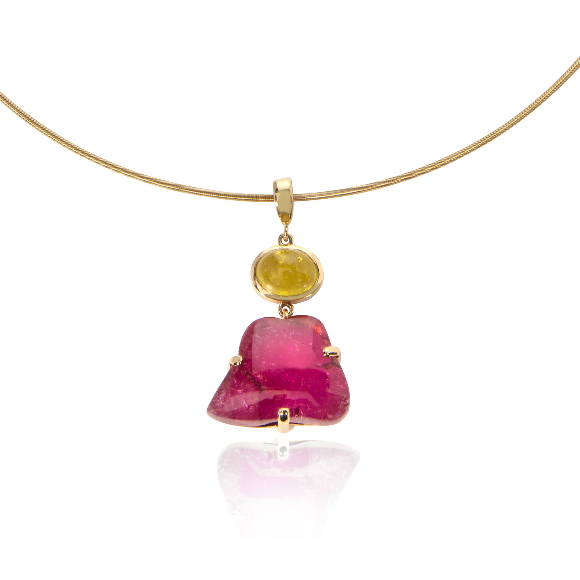 Close up of irregular pink tourmaline pendant on white background