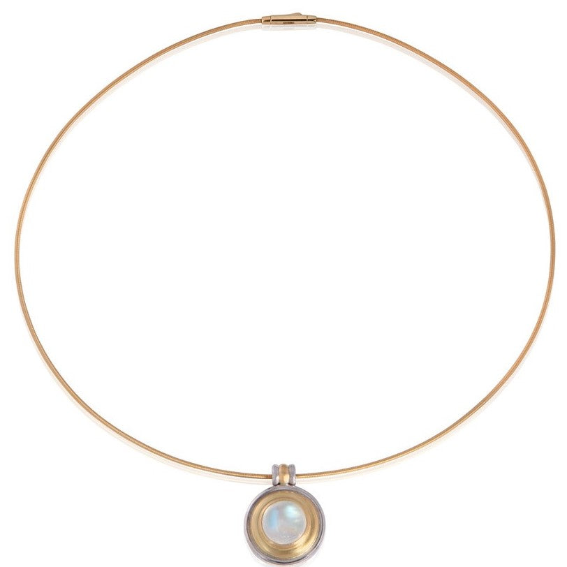 Moonstone cabochon pendant on flexible gold torque pictured on white background