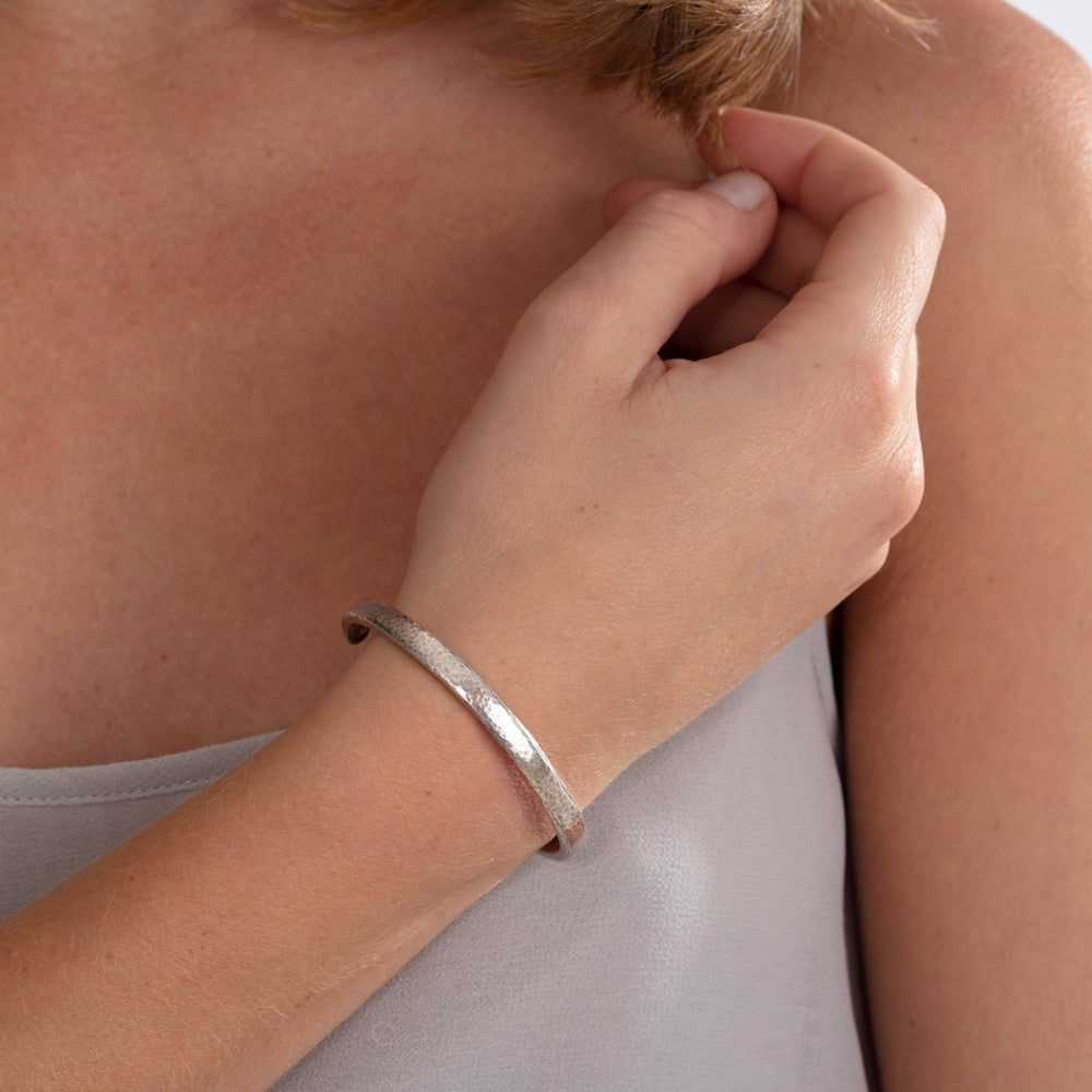 Model pictured wearing silver hammered texture bangle