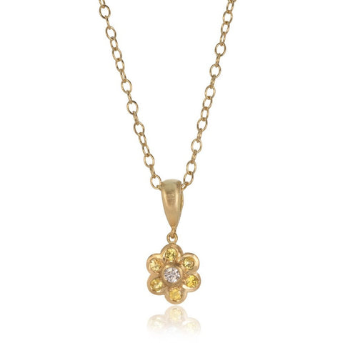 18 carat gold flower pendant necklace with yellow sapphires and diamond on a white background.