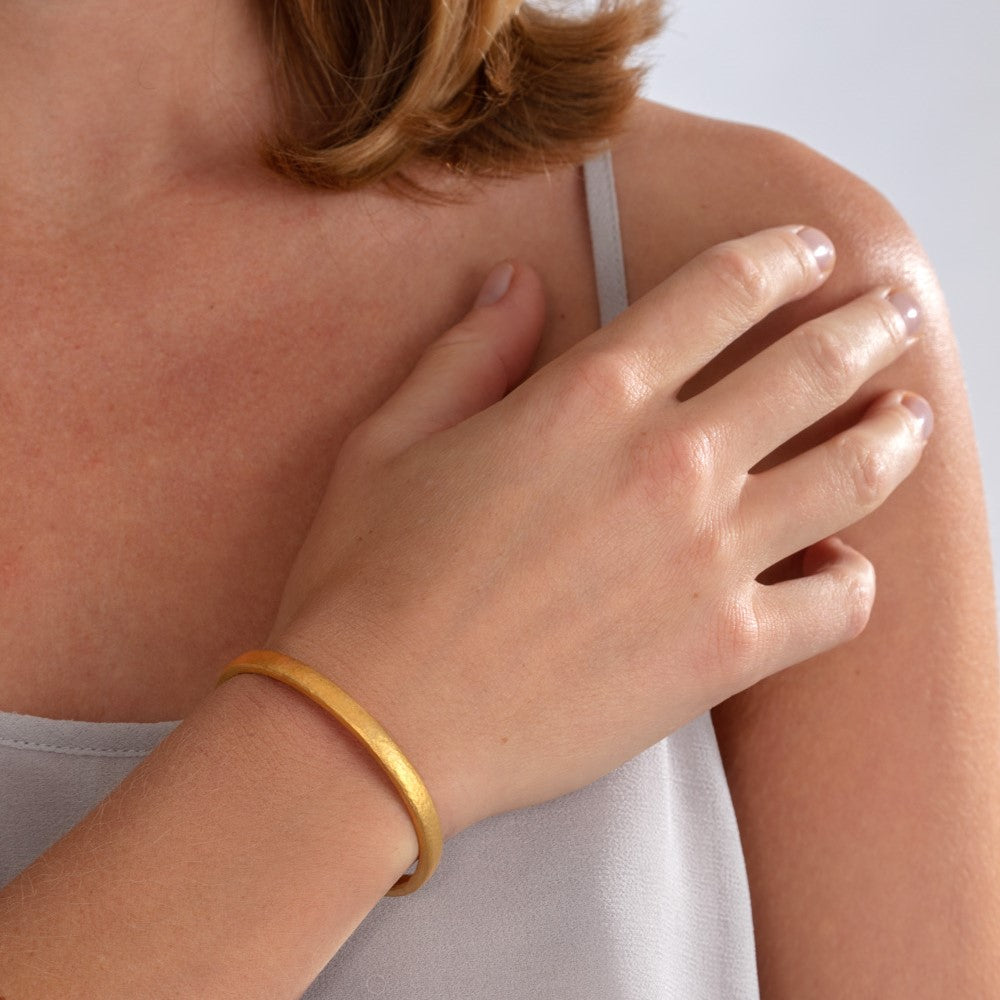 Model pictured wearing silver and yellow. gold micro-plated bangle