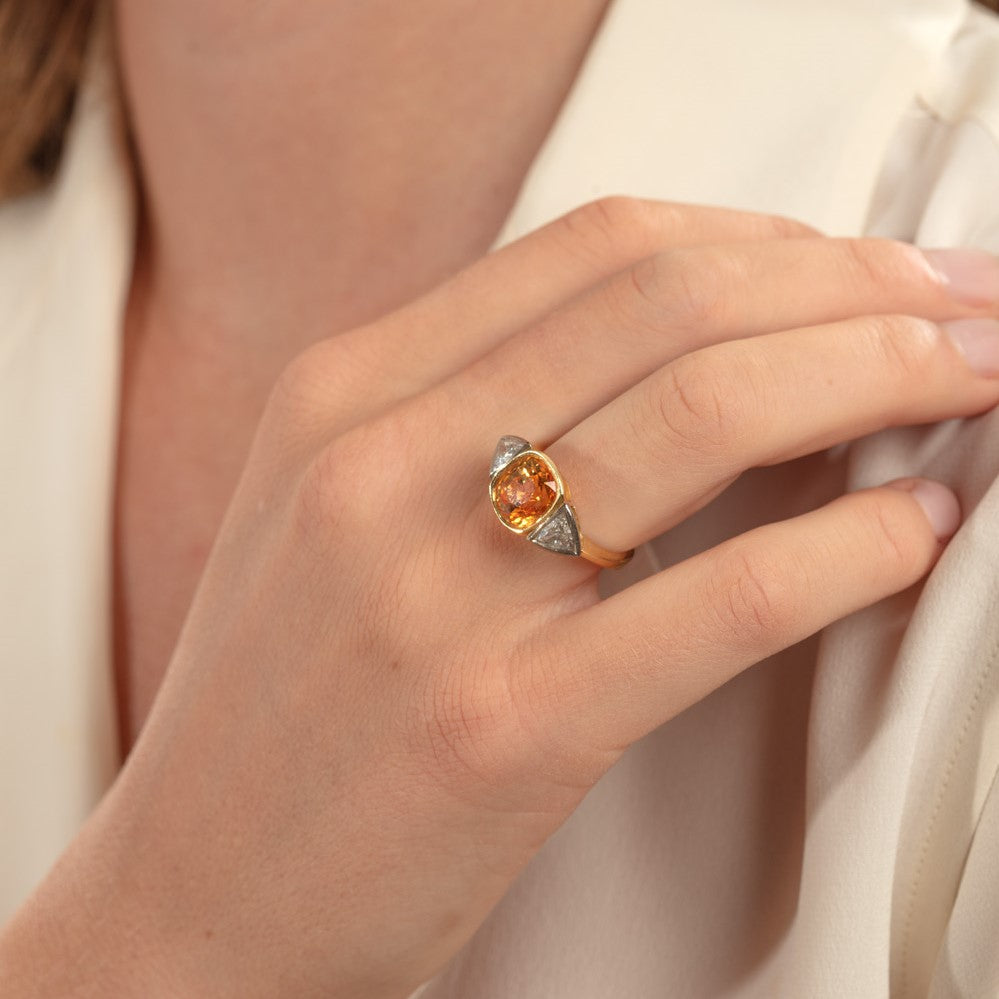 Model pictured wearing yellow sapphire and diamond three stone ring