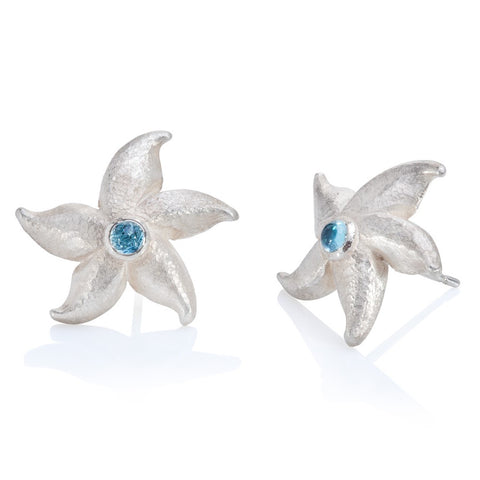 Silver starfish stud earrings set with blue topaz