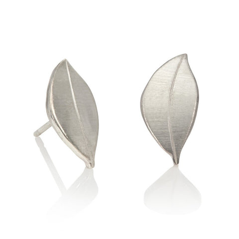 Sterling silver leaf shaped stud earrings on white background