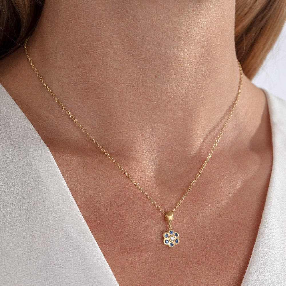 Diamond and sapphire pendant shown on a model