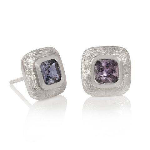 Cushion shaped lilac sapphires set in white gold with line engraving