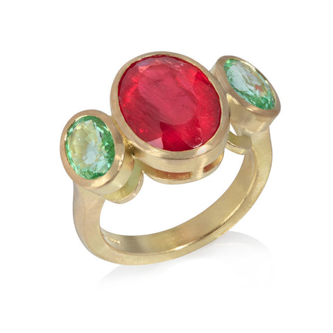 Ring of large oval rhodonite, set in yellow gold, between two oval green Paraiba tourmalines 