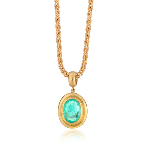 Pendant of stunning oval paraiba tourmaline set in hammered yellow gold, hung on yellow gold chain