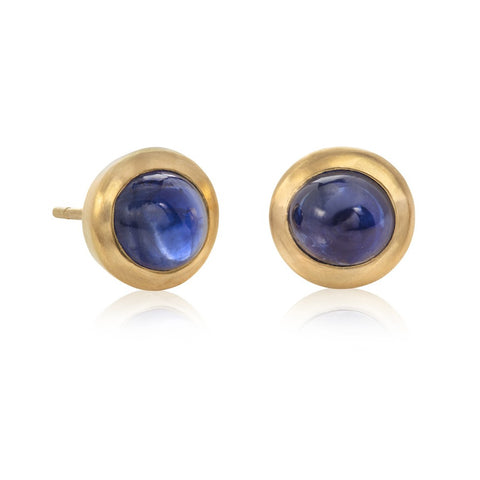 Small blue sapphire stud earrings on white background