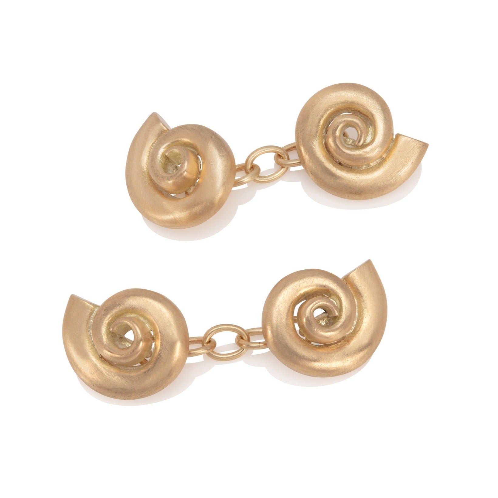Gold shell cufflinks on a white background