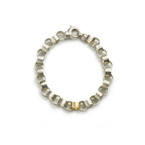 Silver bracelet with links mimicking paper chains, one yellow gold link on white background