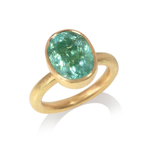 Blue oval Paraiba tourmaline ring pictured on white background