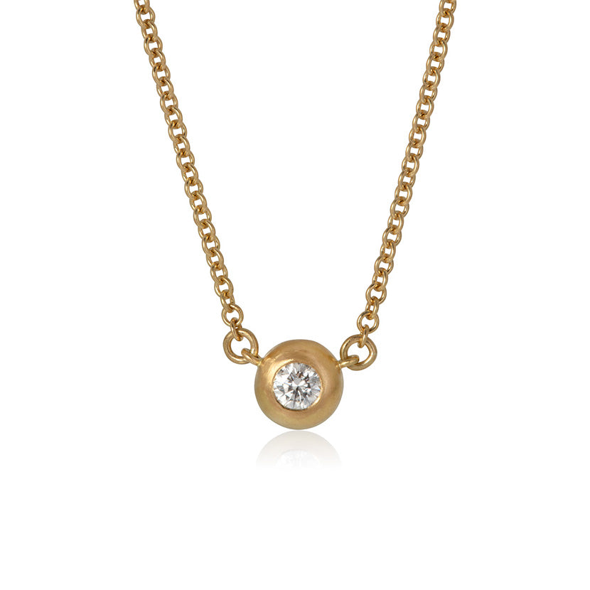 Simple diamond pebble necklace on a white background