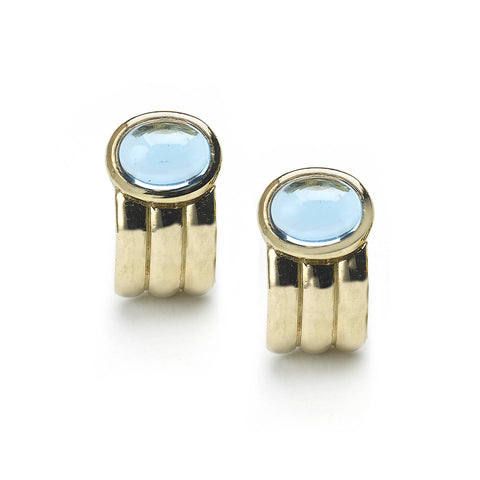 Yellow gold ridged half hoop earrings set with oval blue topaz cabochons