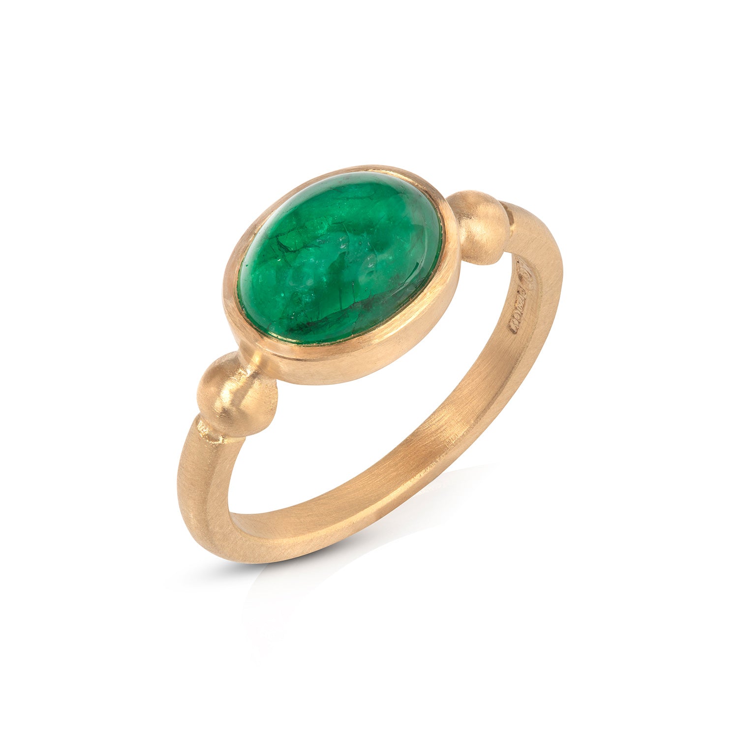 Emerald cabochon ring on white background