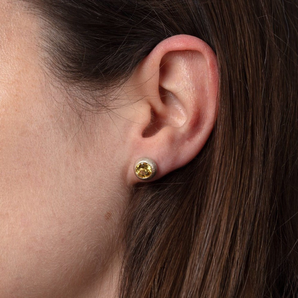 white gold and yellow tourmaline stud earrings shown on a model