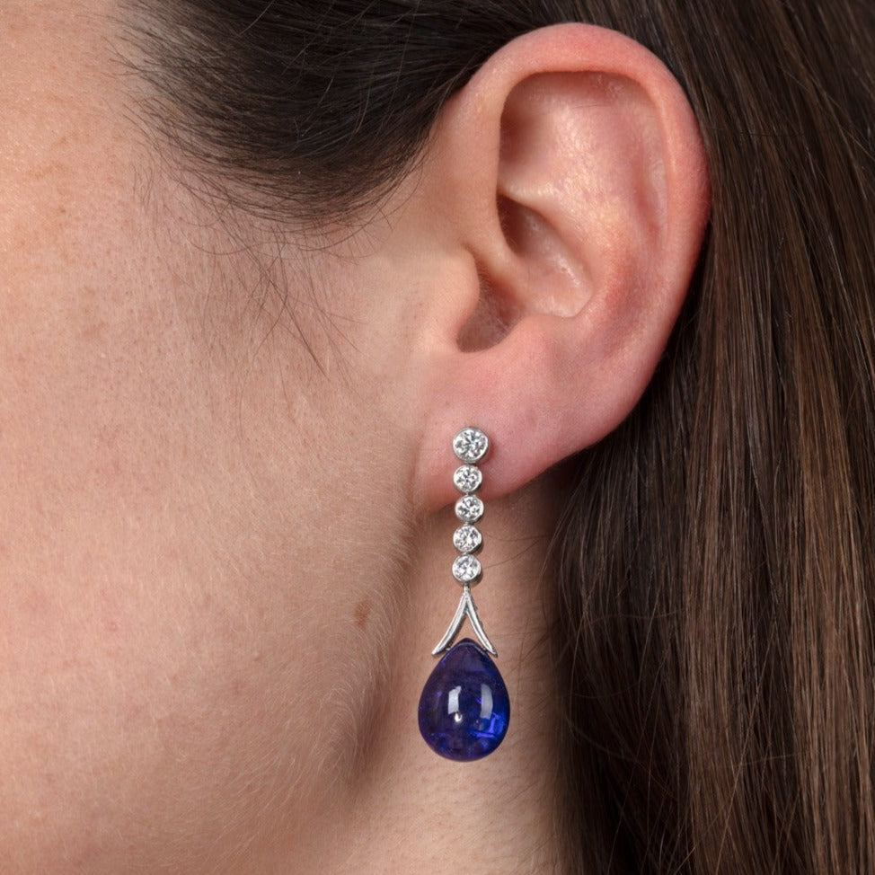 white gold, diamond and tanzanite drop earrings on ear