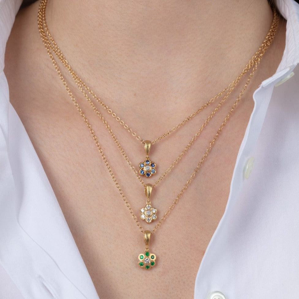 three gold necklaces on a model