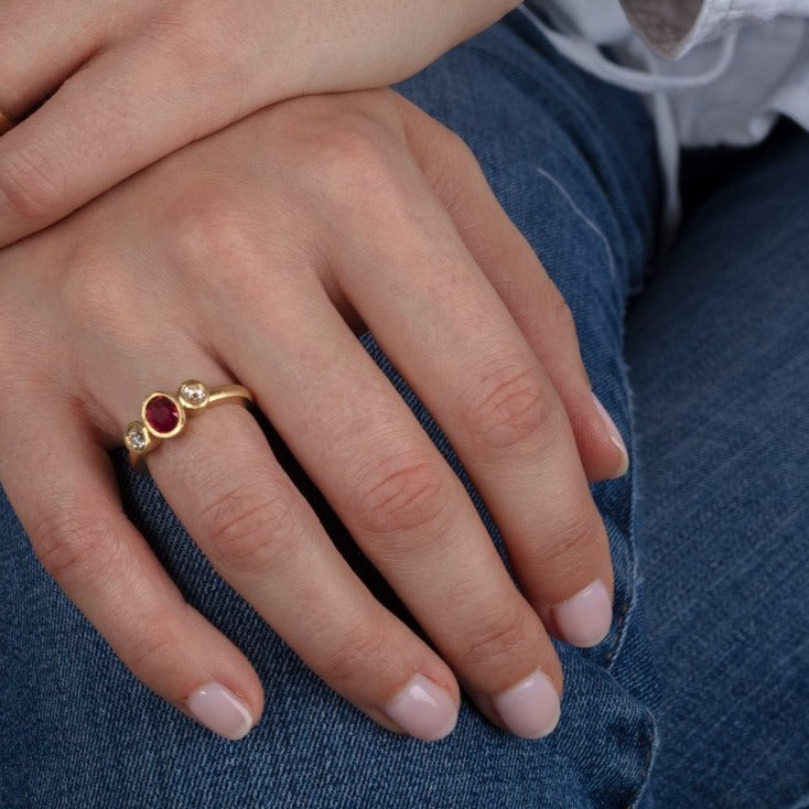 diamond and ruby three stone gold ring shown on a model