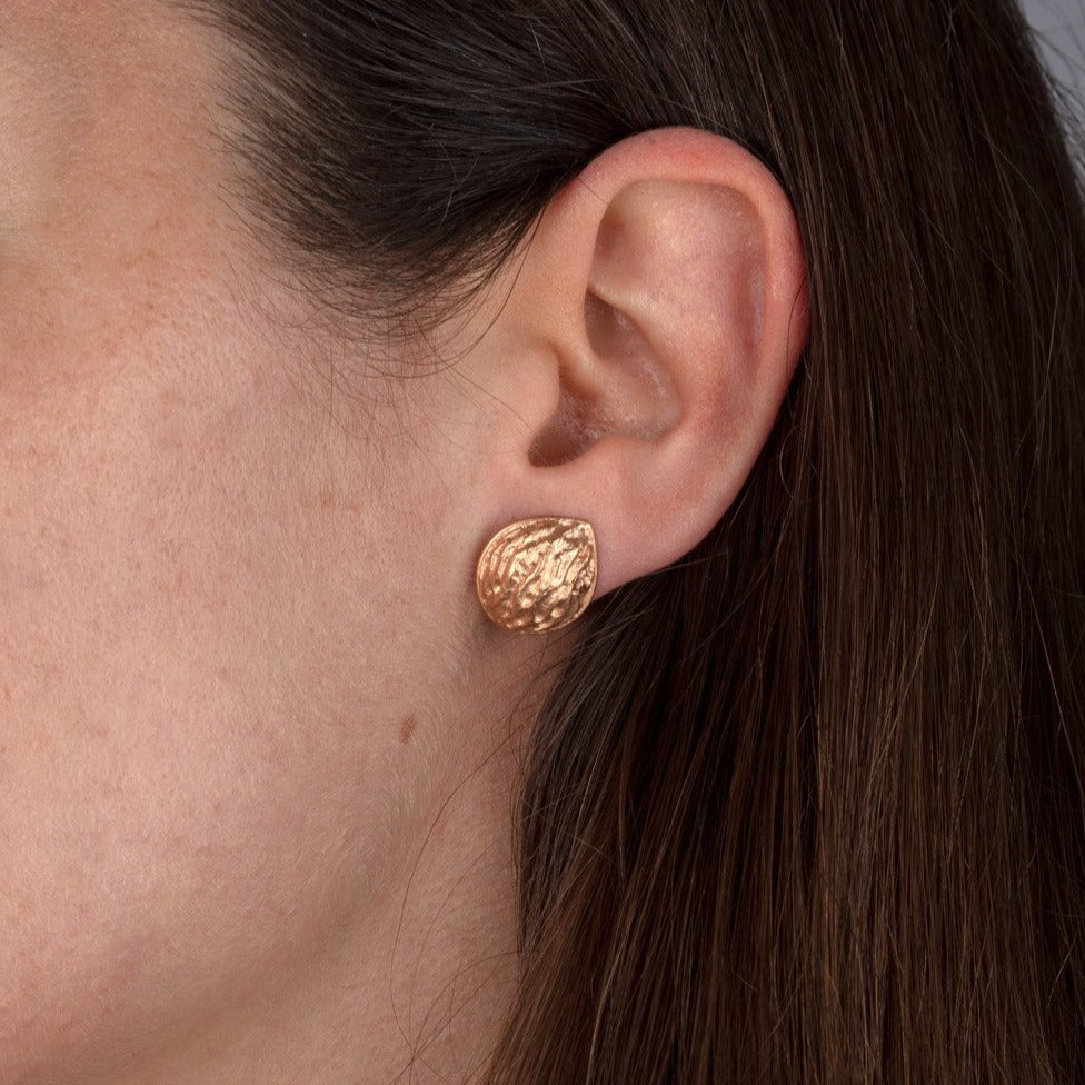 red gold walnut stud earring shown on model