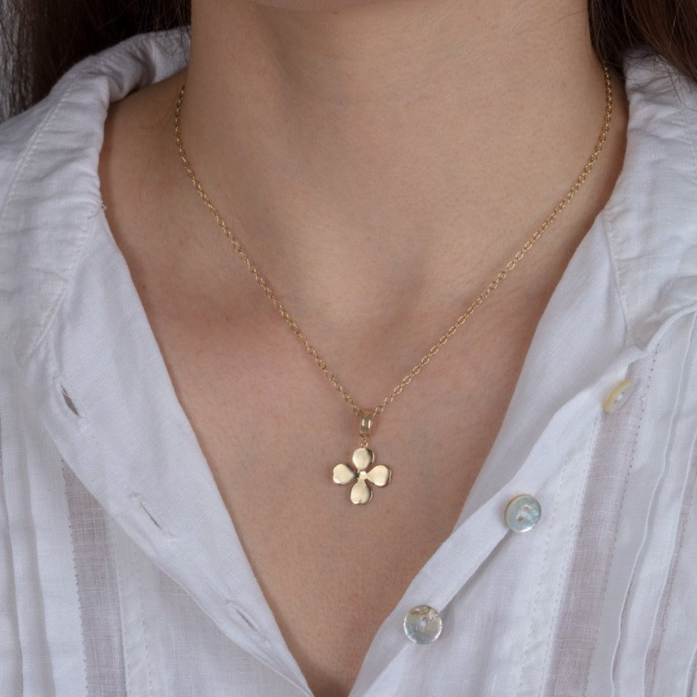 gold 4 leaf clover pendant necklace shown on a model