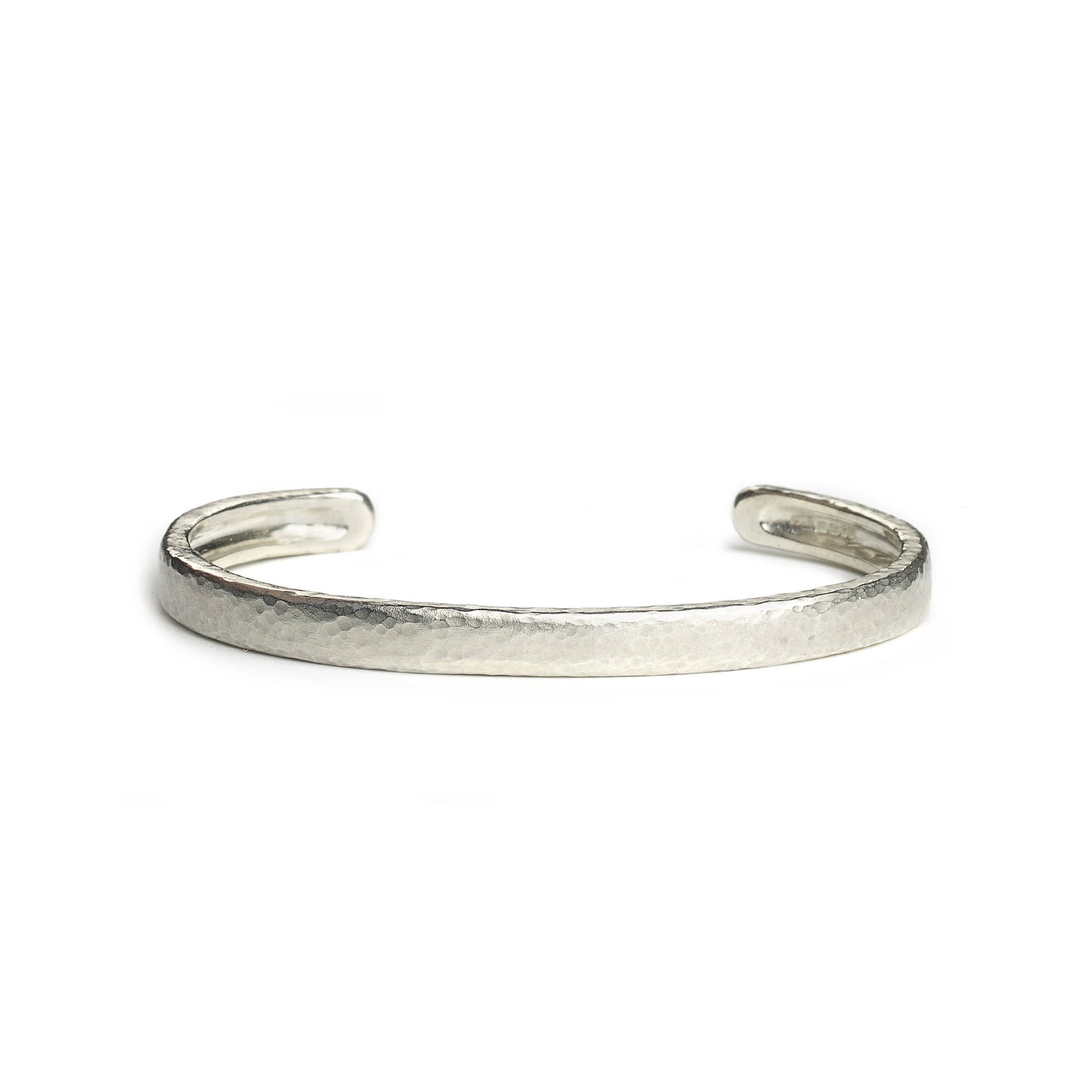 Silver hammered texture bangle on white background