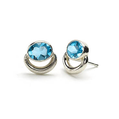 Silver bull ring style stud earrings set with oval blue topaz
