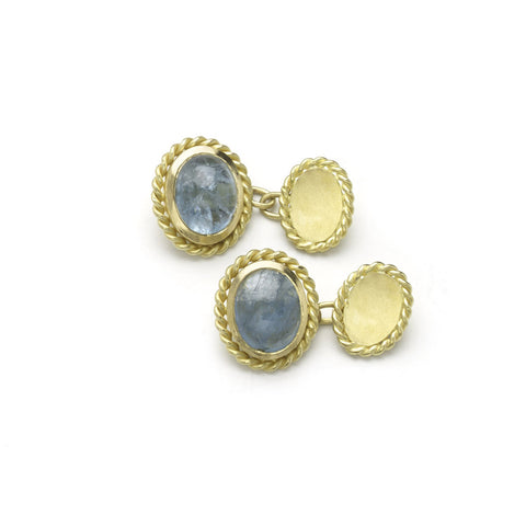 Yellow gold cufflinks set with oval aquamarine cabochons, with twisted yellow gold borders