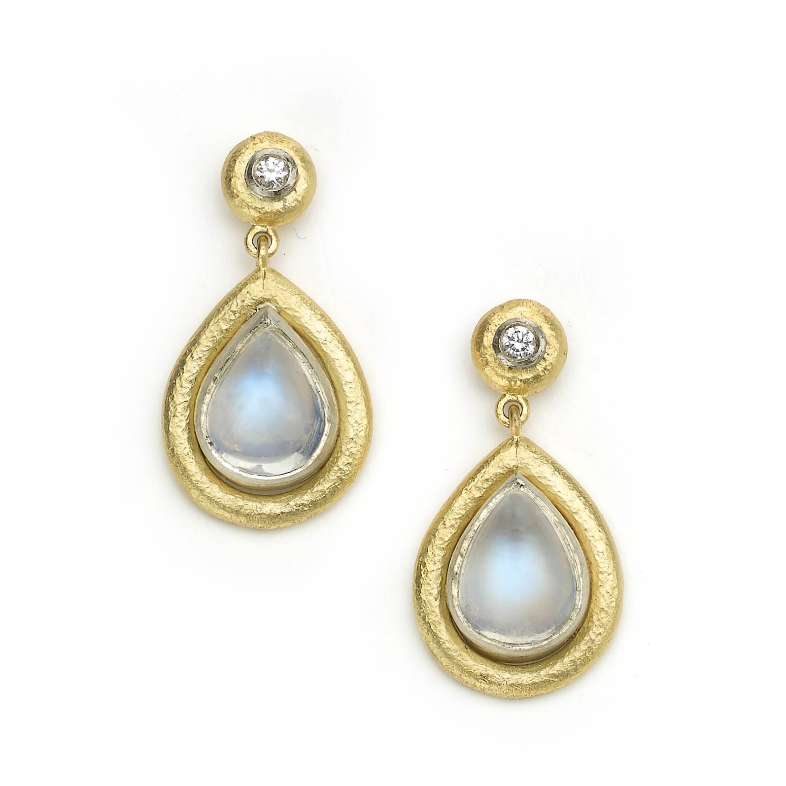 Drop earrings with pear shaped moonstone drops set in white gold with wide hammered texture yellow gold borders, round diamonds are set the same above