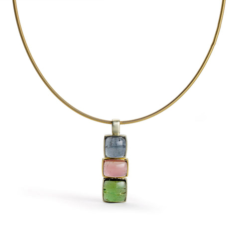Pendant necklace with three rectangular tourmaline cabochons, in blue, pink and green, hung from a flexible gold torque