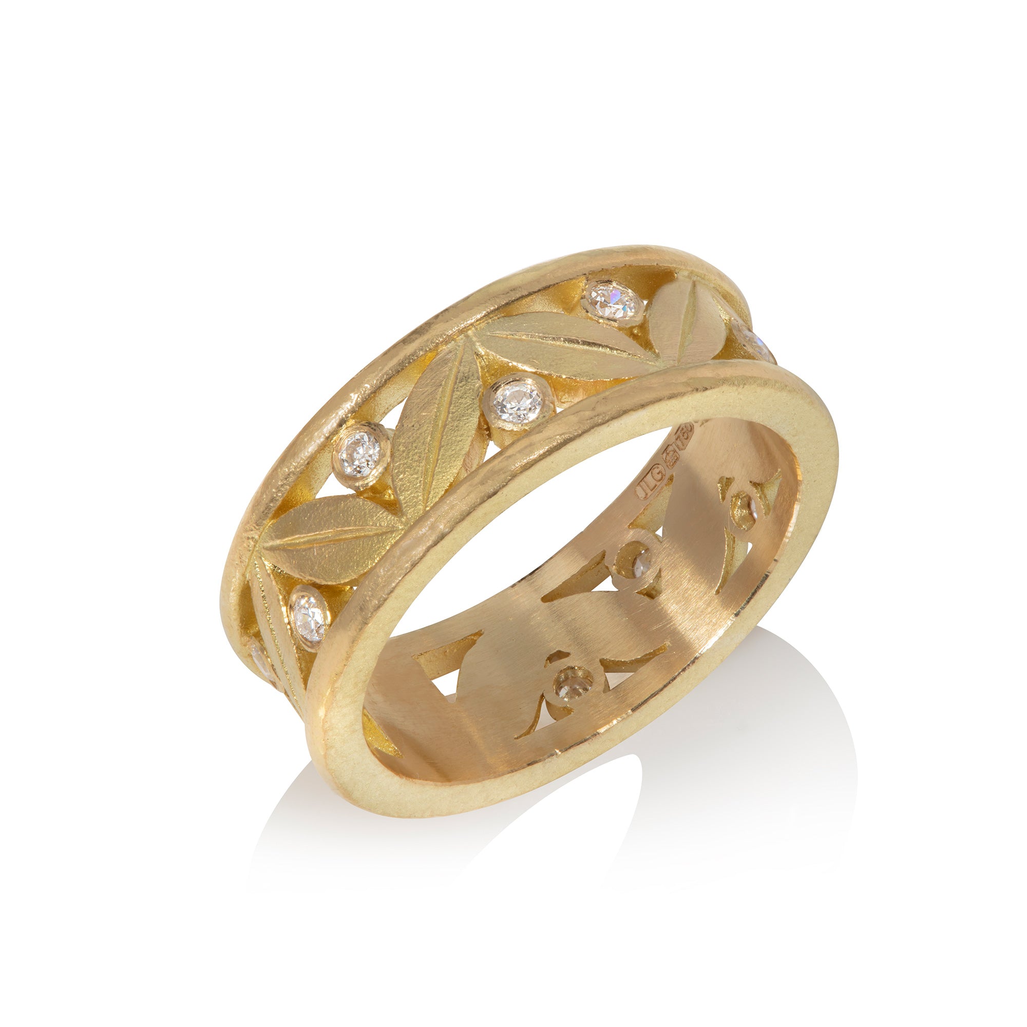 18ct yellow gold ring with leaf motif and diamonds on a white background