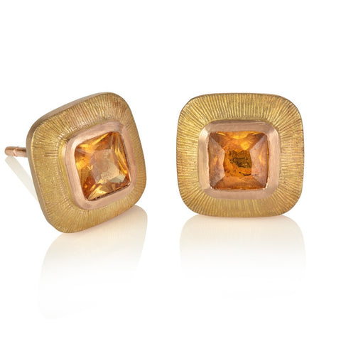 Orange cushion cut sapphires set in wide red gold engraved borders 