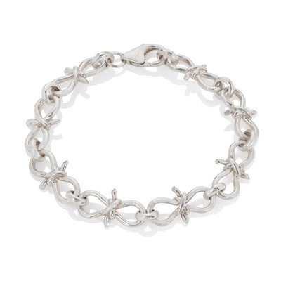 Silver bracelet with links made to look like knots on white background