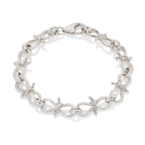 Silver bracelet with links made to look like knots on white background