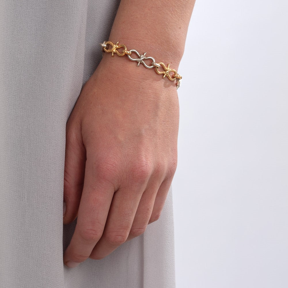 Yellow gold and silver nautical knot bracelet pictured on a model