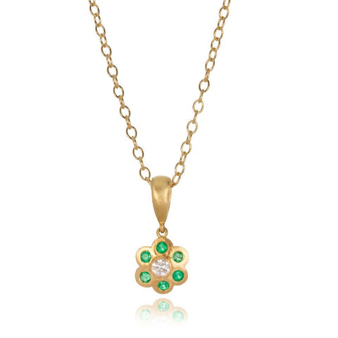 18 carat yellow gold, emerald and diamond pendant necklace on a white background.
