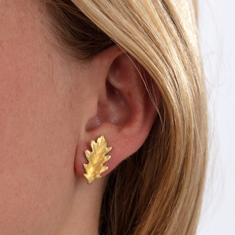 Model pictured wearing yellow gold oak leaf earrings